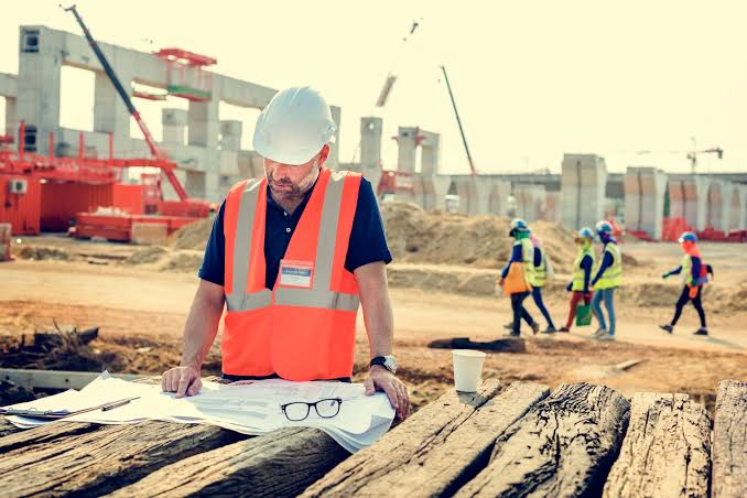 Construction site with workers, earthworks and structures