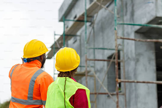 Construction workers viewing a building under construction